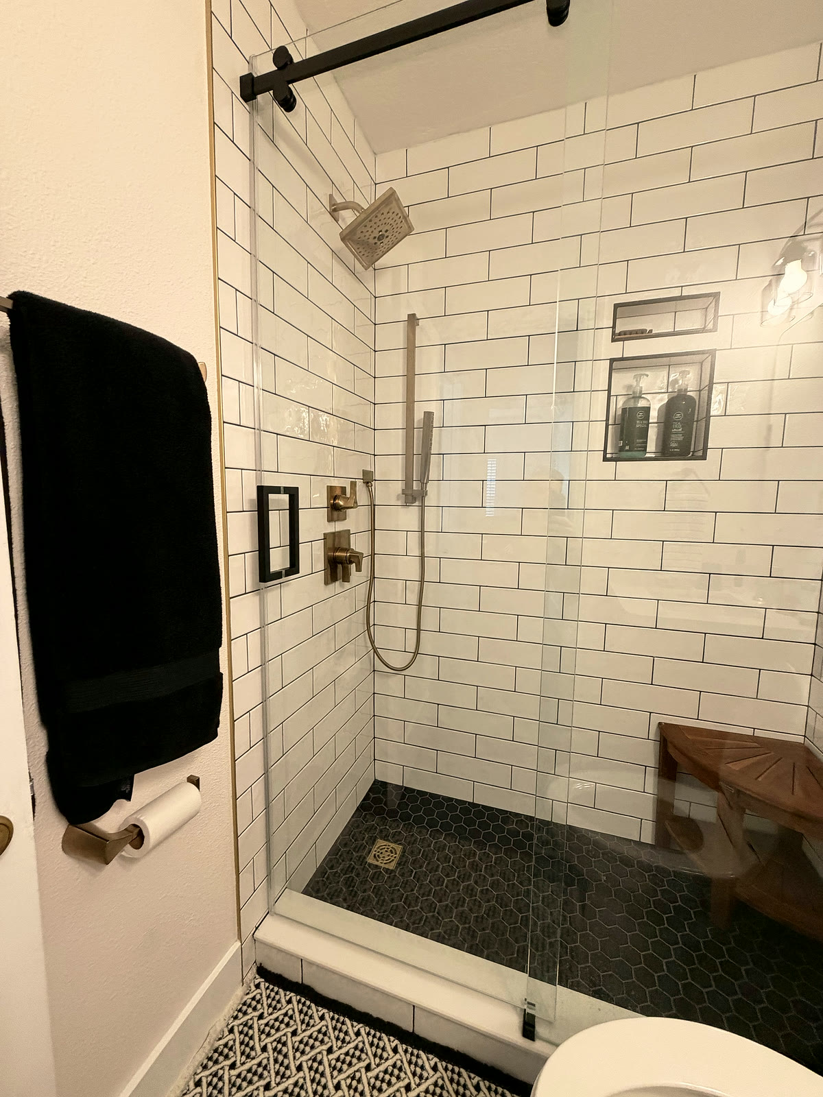 Custom glass walk-in shower with subway tile in a St. Petersburg bathroom remodel by 618 Construction